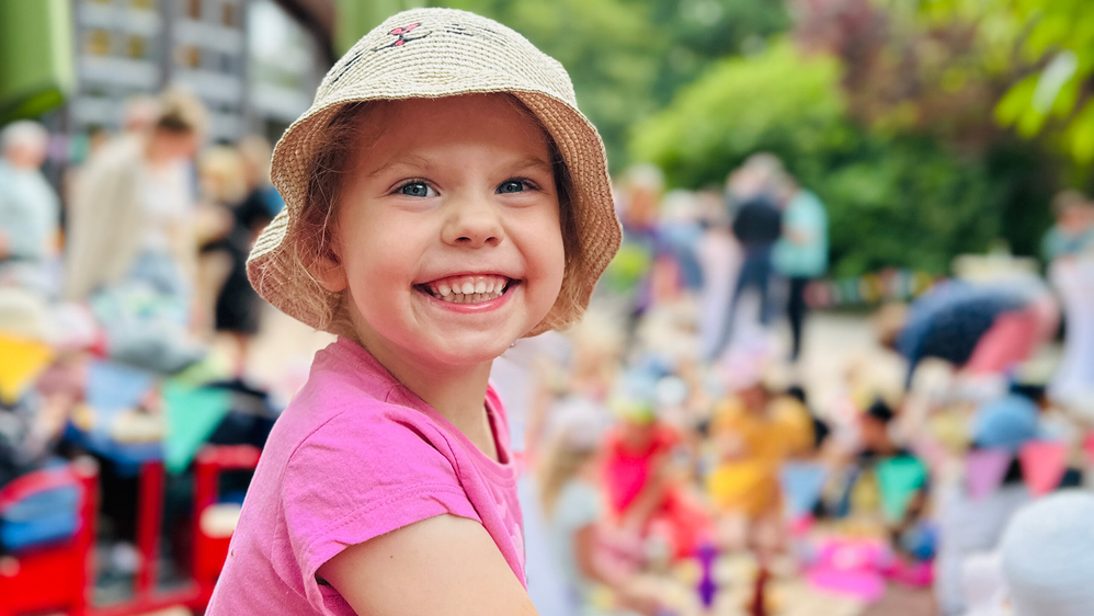 Lachendes Mädchen im Kindergarten auf dem Spielplatz